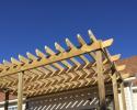We can build a pergola in your backyard to shade a stone patio or wood deck using wood beams and lattice set on classical style columns.
